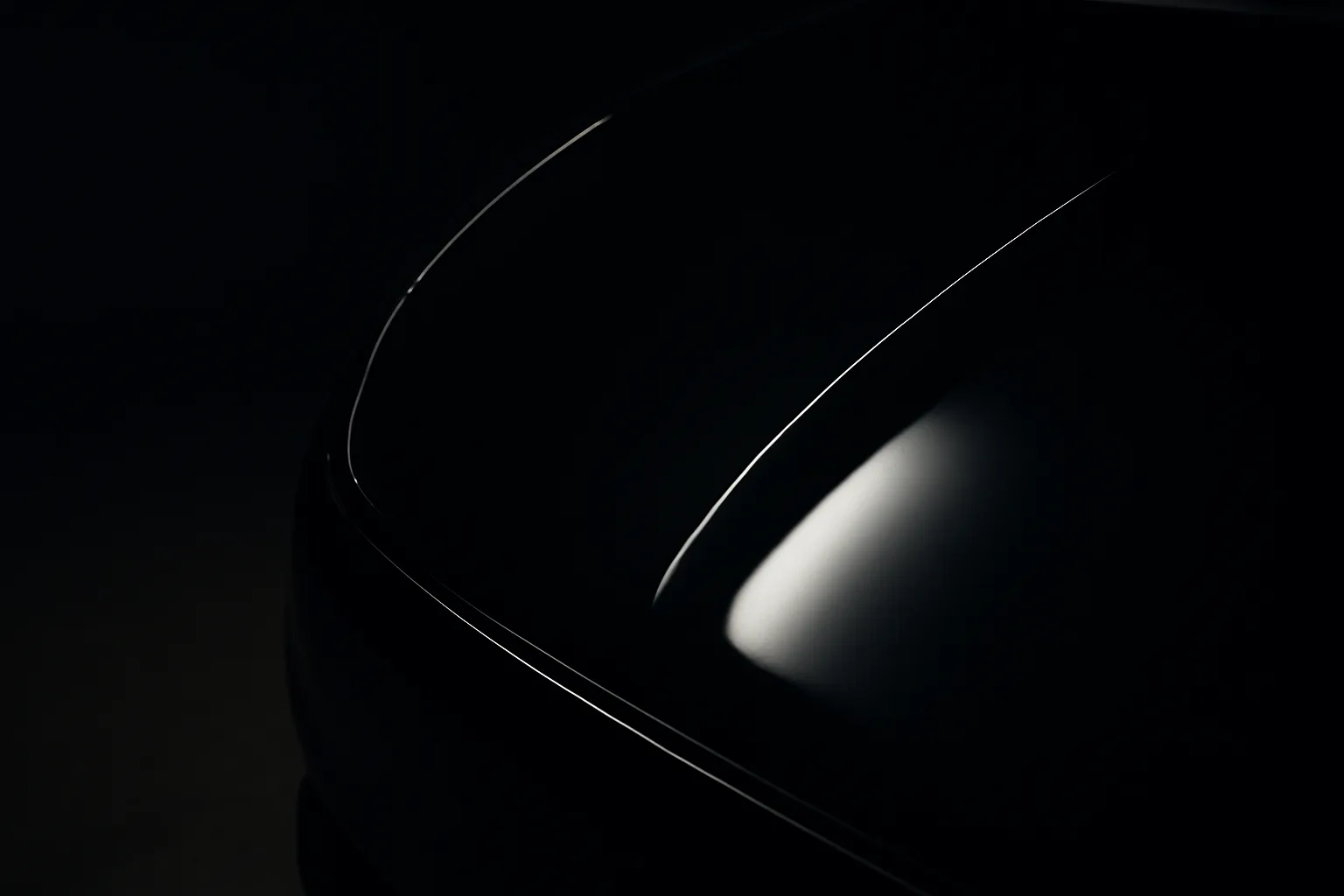 Premium car detailing studio — high-gloss paint surface under studio lighting